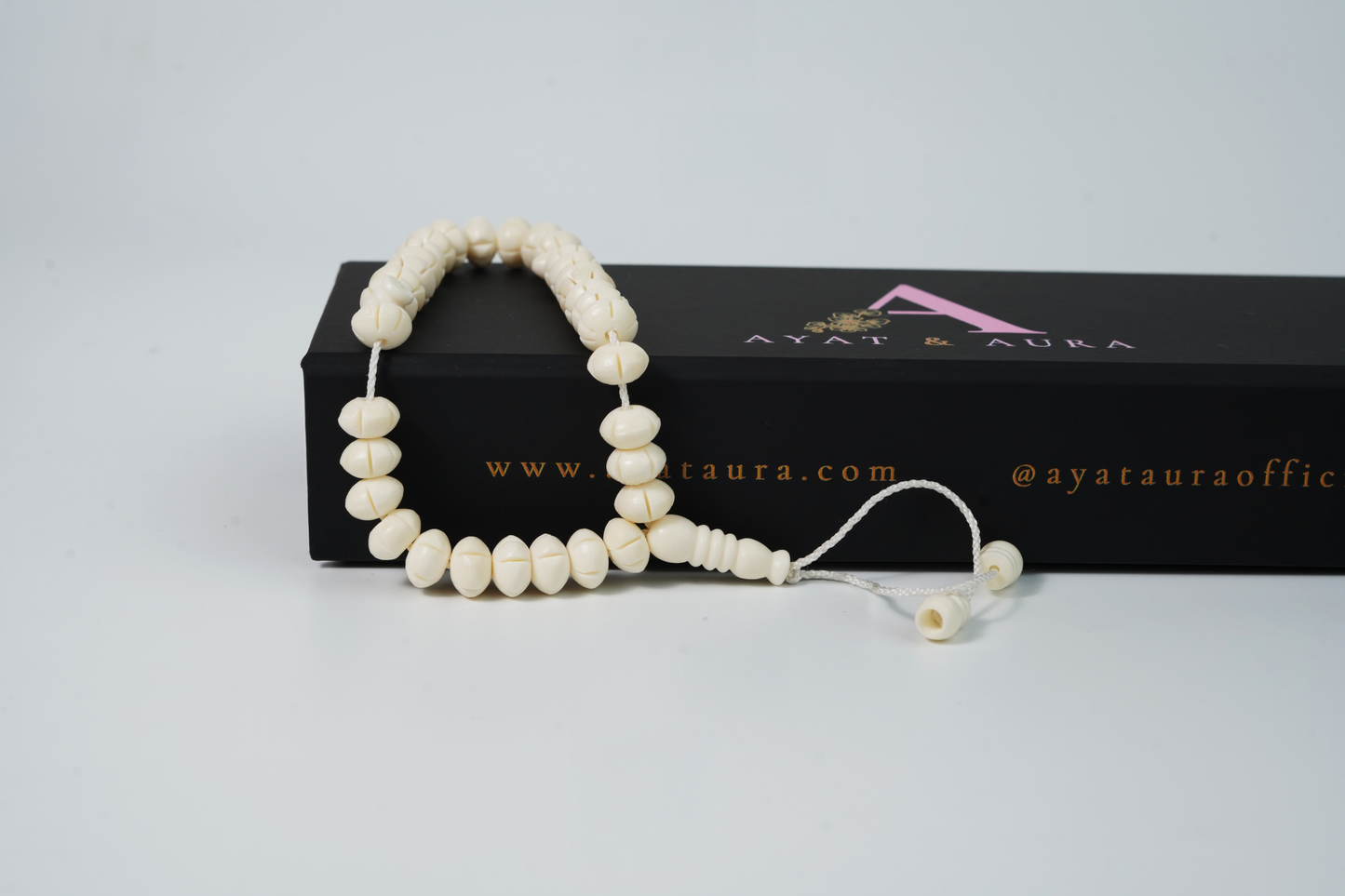 Close-up of carved bone beads and ivory cord