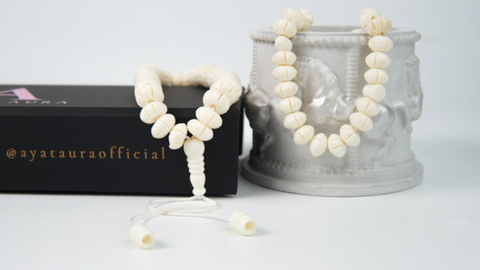 Close-up of carved bone beads and ivory cord