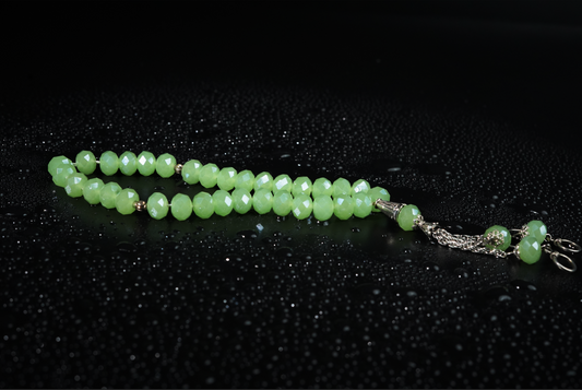 Mint-green resin tasbih on dark textured backdrop
