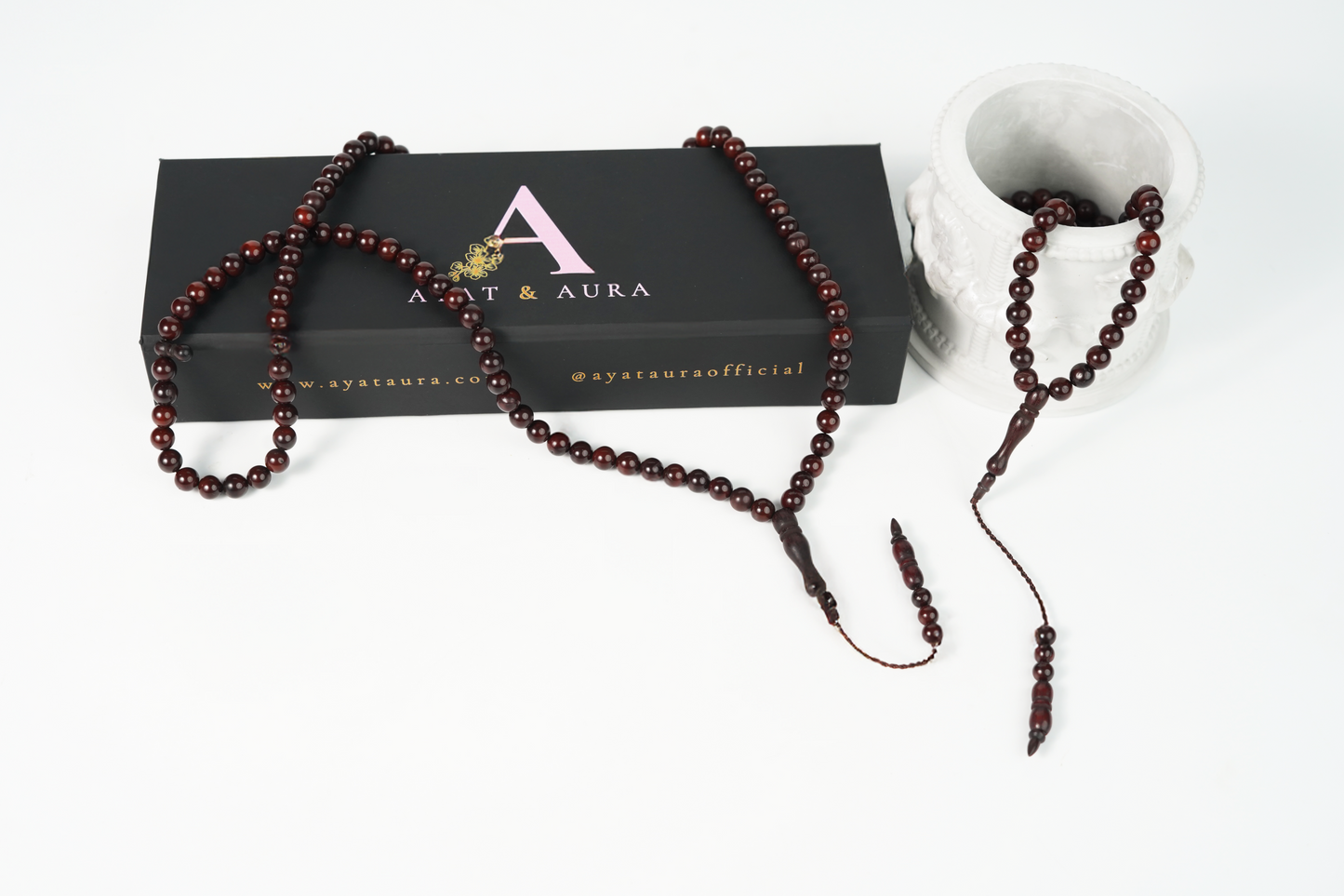 Cocoa-tone wood tasbih (99 beads) on neutral linen flatlay