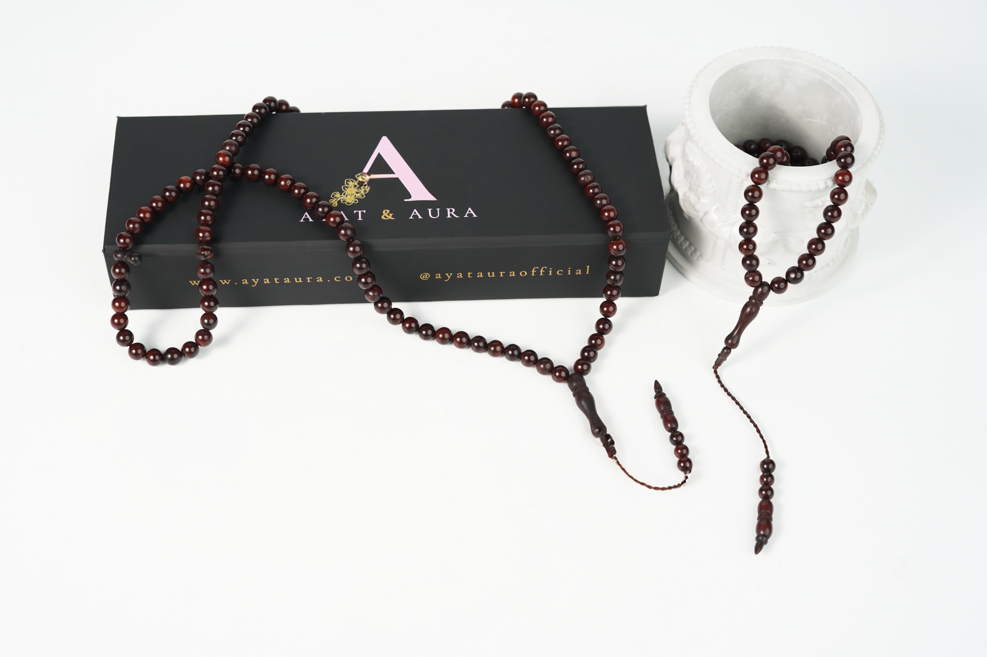 Cocoa-tone wood tasbih (99 beads) on neutral linen flatlay