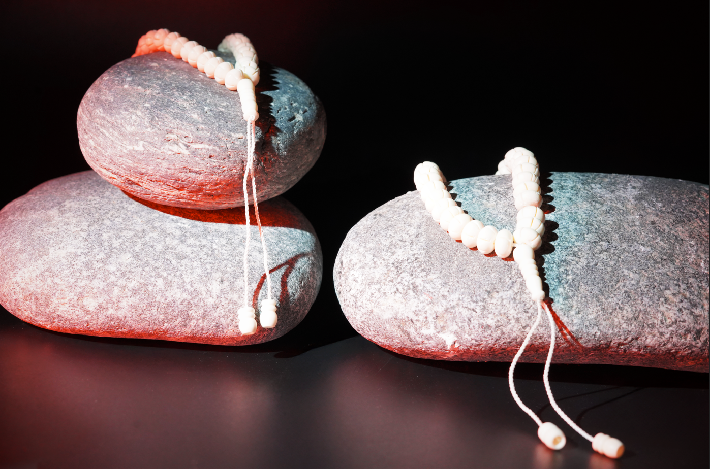 Bone prayer beads styled on river stones
