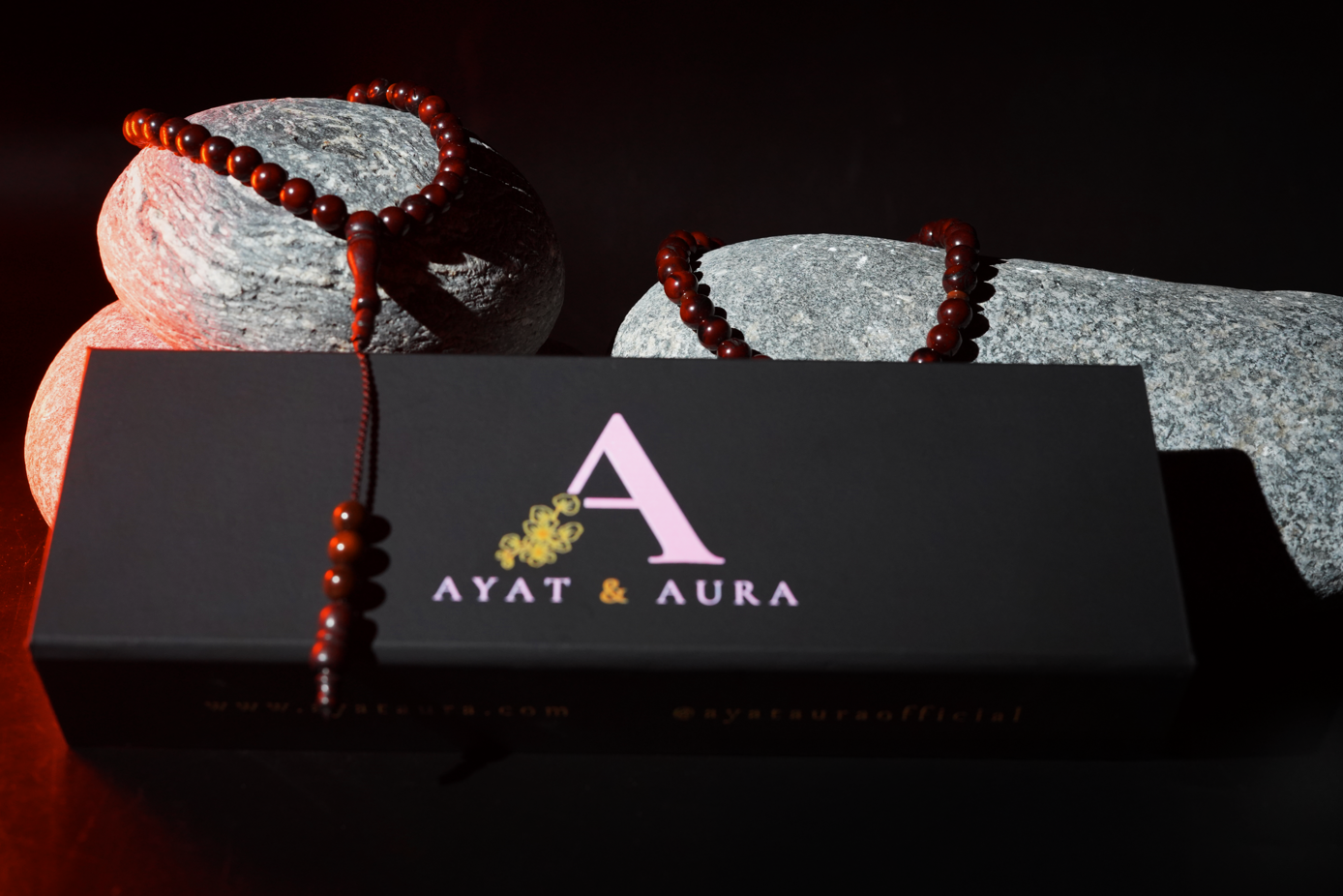 Wooden tasbih styled on stones — warm highlights, premium mood