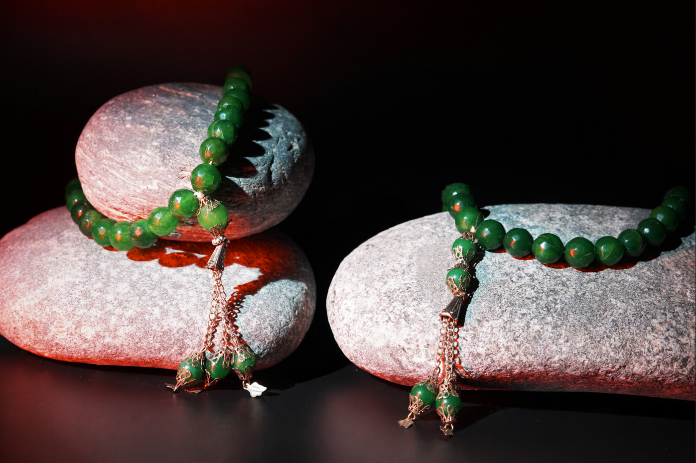 Two Agate green Tasbih on stones with textured background