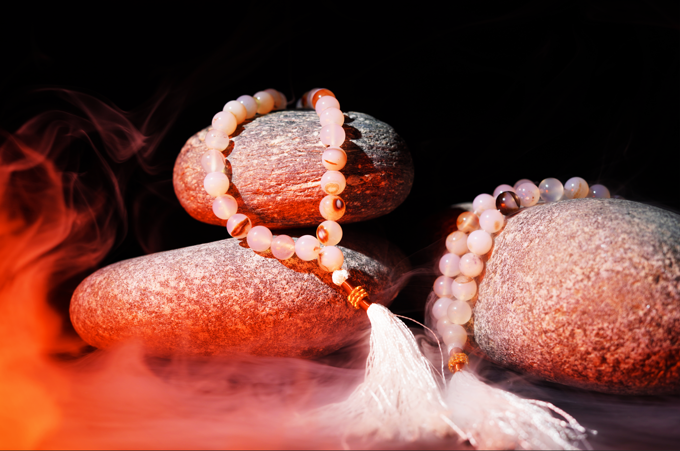 Agate prayer beads styled on stones with mist